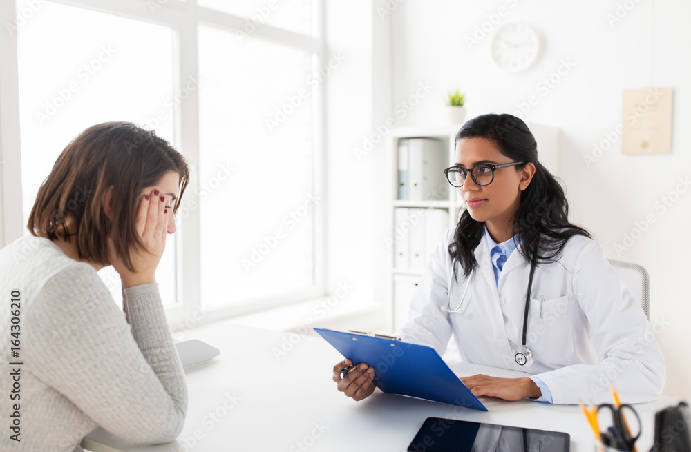 doctor with clipboard and woman patient at clinic doctor with clipboard and woman patient at clinic