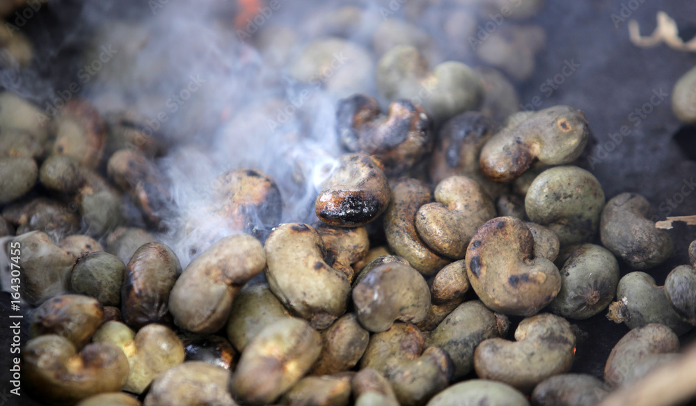 smoke and fire over roasted cashew nuts smoke and fire over roasted cashew nuts