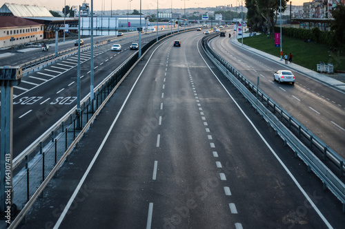 Asphalt highway on Bosporus with three lanes and cars passing by. with street lights. Picture taken from the bridge