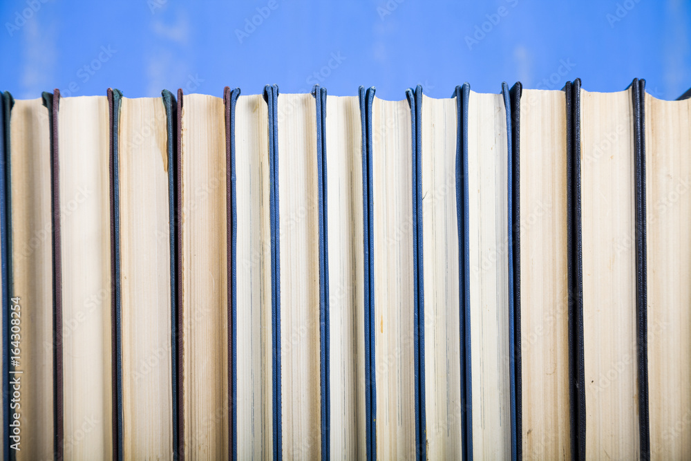 Stack of books on a blue background. Stack of books on a blue background.
