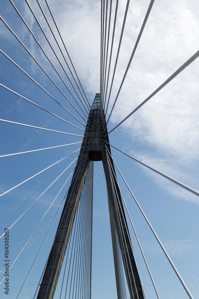 Suspension bridge against blue and cloudy sky Suspension bridge against blue and cloudy sky
