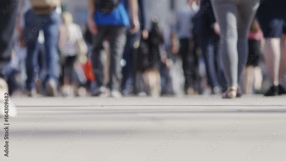 Pedestrian commuters feet walking in the morning light Pedestrian commuters feet walking in the morning light