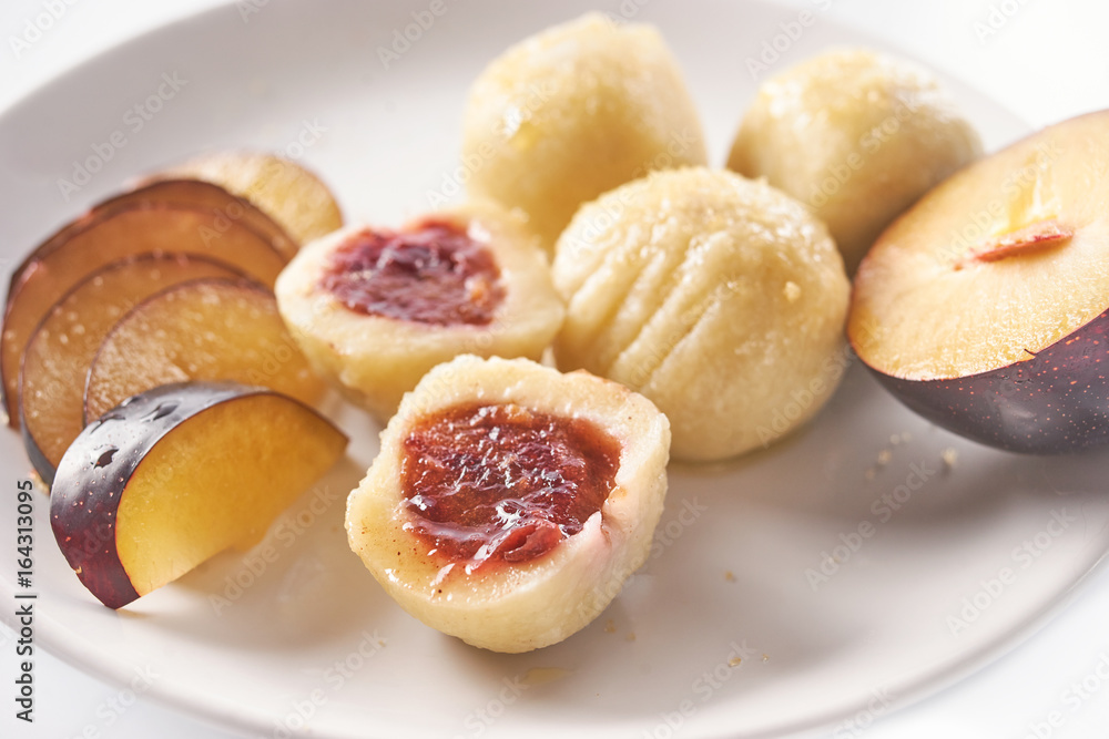 Austrian traditional dumplings filled with plum on white Austrian traditional dumplings filled with plum on white