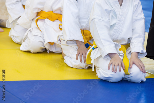 Group of children in kimono sitting on tatami. Selective focus