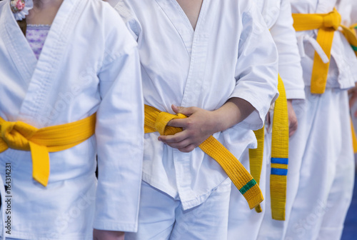 Children in kimono on martial arts training seminar. Selective focus