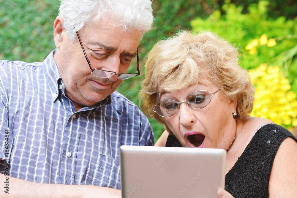Elderly couple using tablet. Elderly couple using tablet.