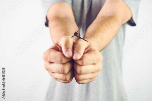Tied Man Hands With Cable Ties Closeup High Contrast