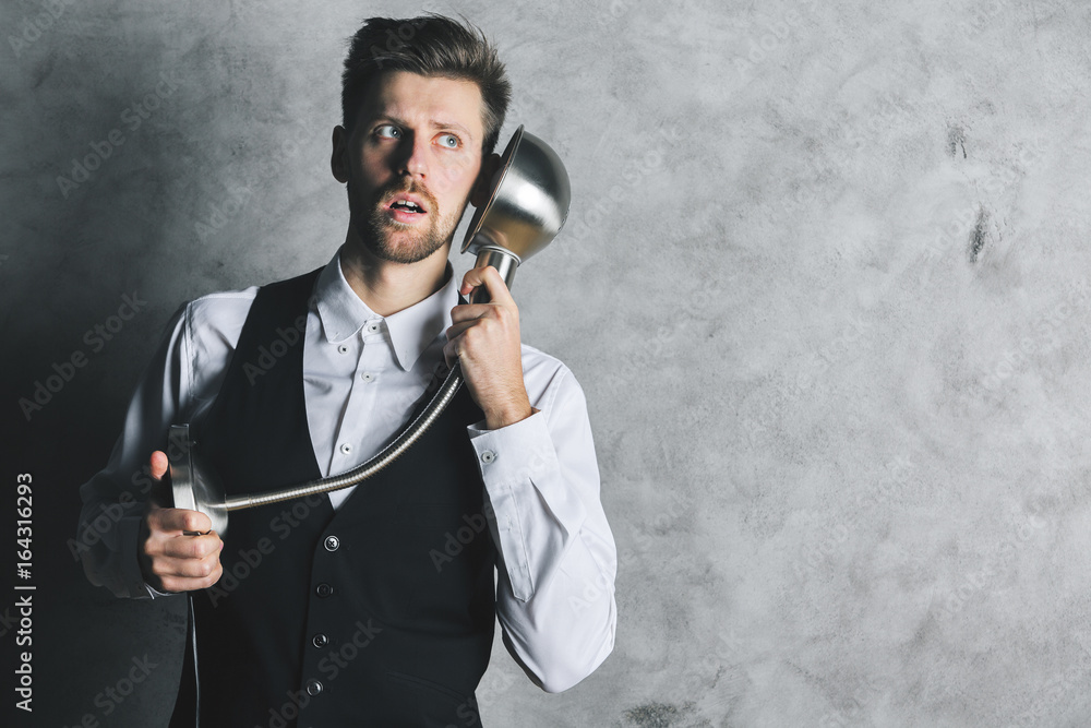 Naklejka premium Crazy businessman with lamp phone