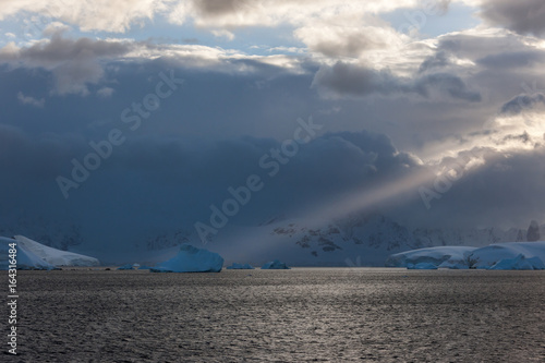 Stom clouds with light beam hitting icebergs along the Antarctic Peninsula.