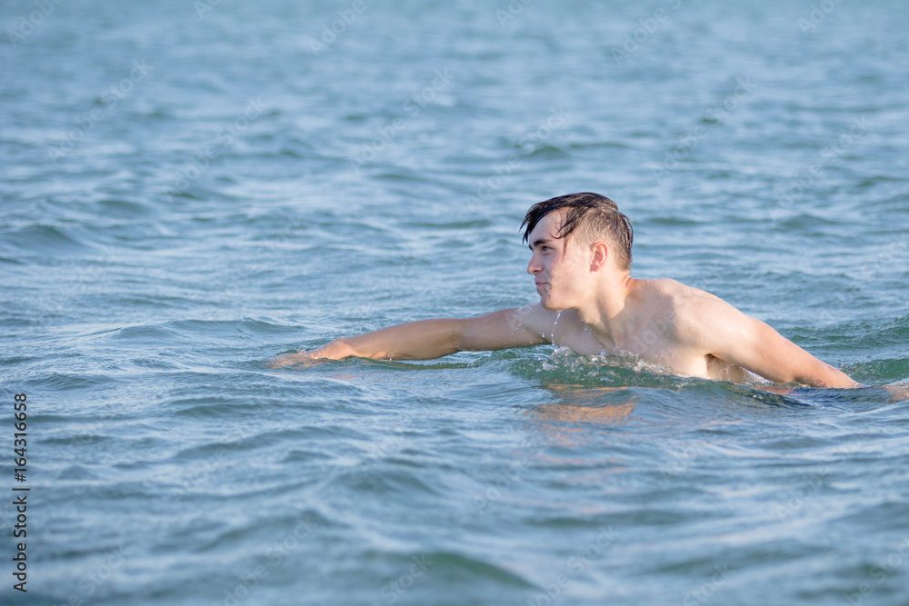 Teenage boy in the sea on a summer's day