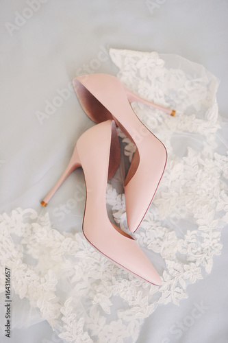 beige wedding shoes on a neutral light lacy background