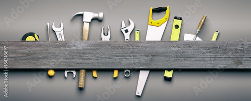 Hand tools on grey wooden background. 3d illustration