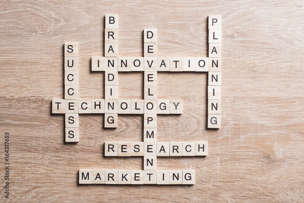 Conceptual media keywords on table with elements of game making crossword Conceptual media keywords on table with elements of game making crossword
