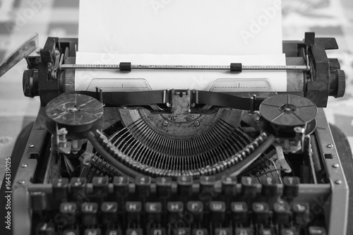 retro typewriter with blank sheet