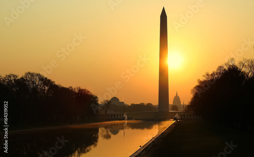 Sun rising behind the Washington Monument and Reflecting Pool