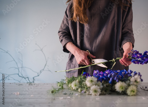 Midsection of woman cutting flowers photo