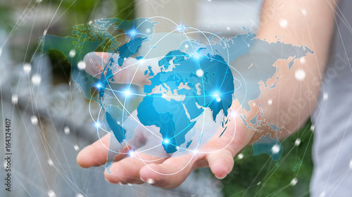 Fototapeta Naklejka Na Ścianę i Meble -  Businessman holding global network on planet earth 3D rendering