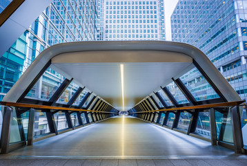 London, England - Public pedestrian cross rail footbridge at the financial district of Canary Wharf with skyscrapers