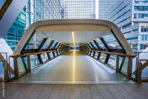 London, England - Public pedestrian cross rail footbridge at the financial district of Canary Wharf with skyscrapers