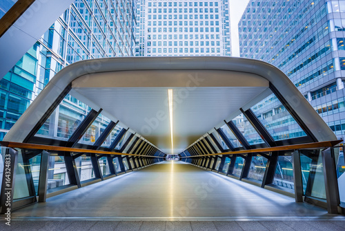 London, England - Public pedestrian cross rail footbridge at the financial district of Canary Wharf with skyscrapers photo
