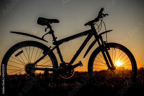 Silhouette of mountain bicycle on the sunset background