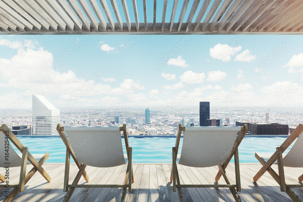 Row of white chairs near a pool in a city Row of white chairs near a pool in a city