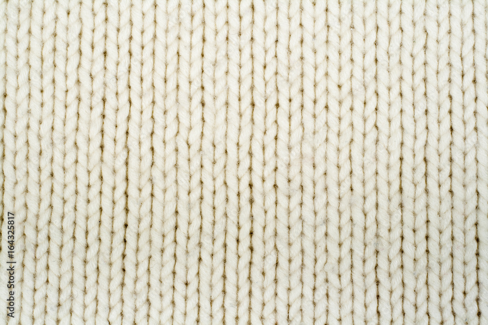 Sweater or scarf fabric texture large knitting. Knitted jersey background with a relief pattern. Wool hand- machine, handmade. Sweater or scarf fabric texture large knitting. Knitted jersey background with a relief pattern. Wool hand- machine, handmade.