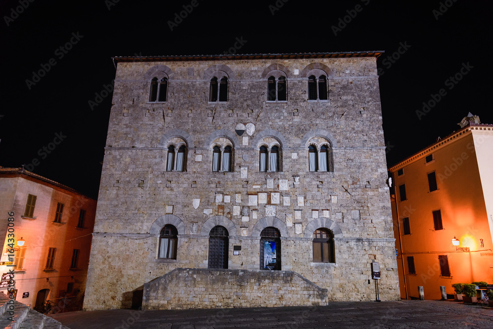 Night view of the facade of the municipal building of Massa Marittima, a small town in the province of Grosseto in Tuscany