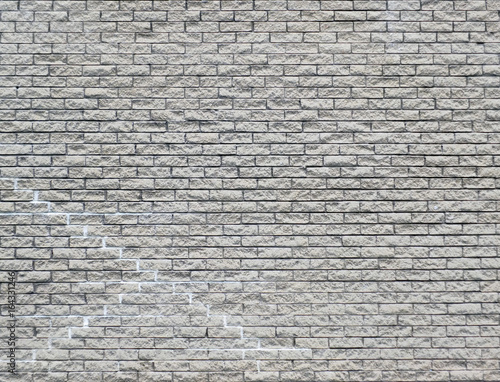white brick wall background with cracks and repairs repeating pattern
