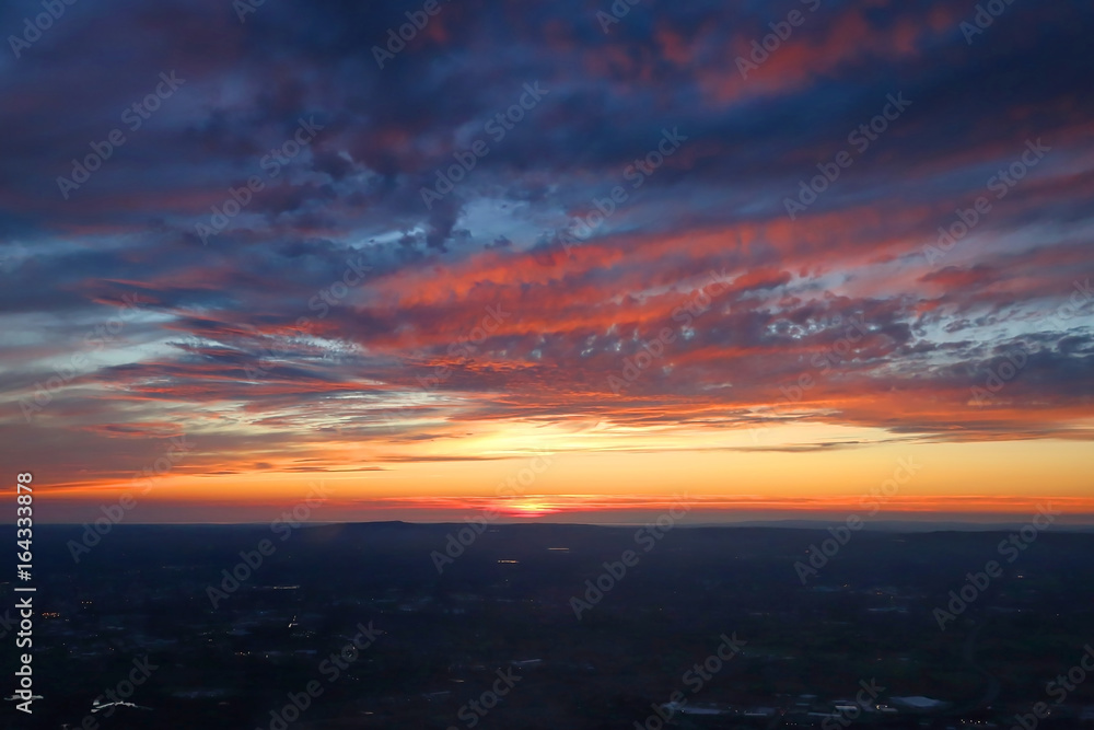 Dramatic aerial view of a colorful sunset over Manchester, England.
