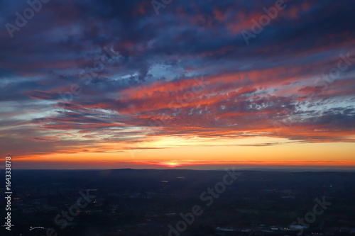 Dramatic aerial view of a colorful sunset over Manchester, England.