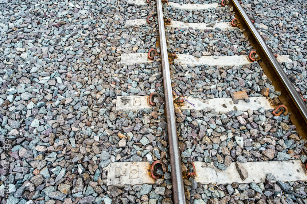 Railroad tracks with Stone texture background Railroad tracks with Stone texture background