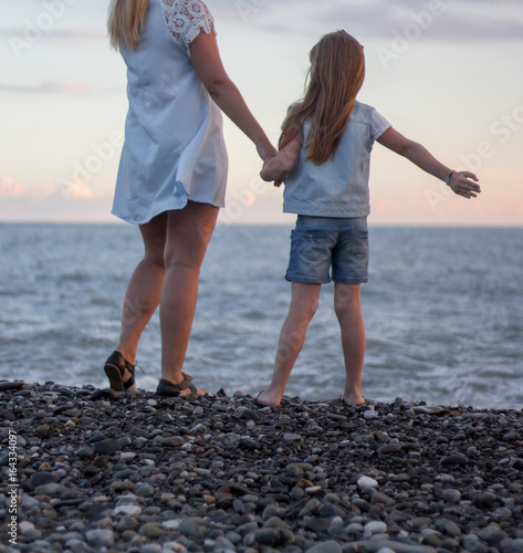 Mother and daughter are standing on the beach © 0635925410