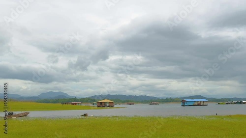 Floating houses floating in the lake with overcast weather.  photo