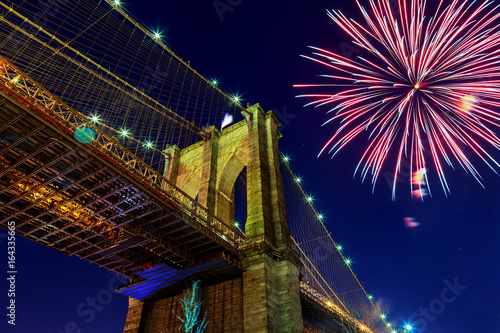 Firework over city at night with reflection in water