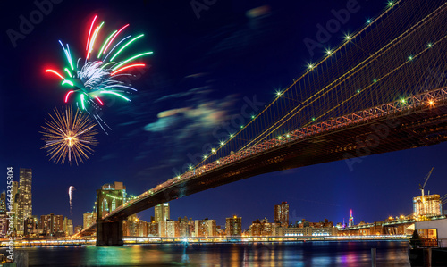 Firework over city at night with reflection in water