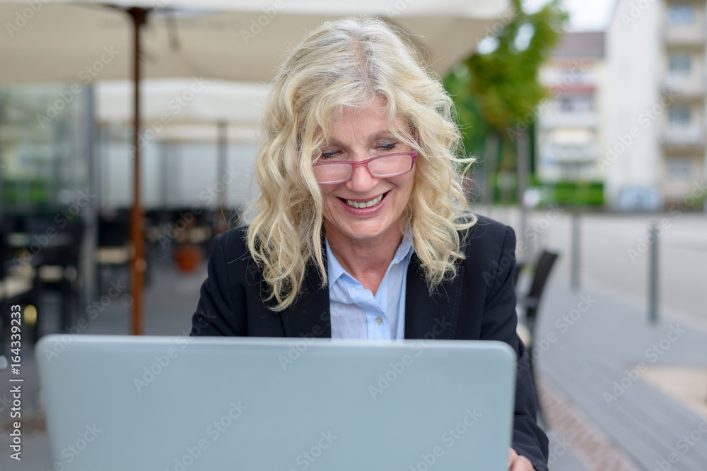 Middle-aged businesswoman working on her laptop Middle-aged businesswoman working on her laptop