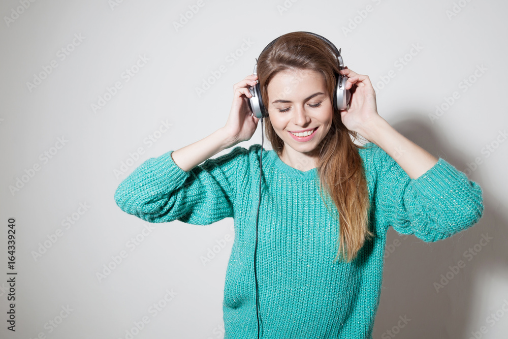 Fototapeta premium beautiful girl listens to music in headphones