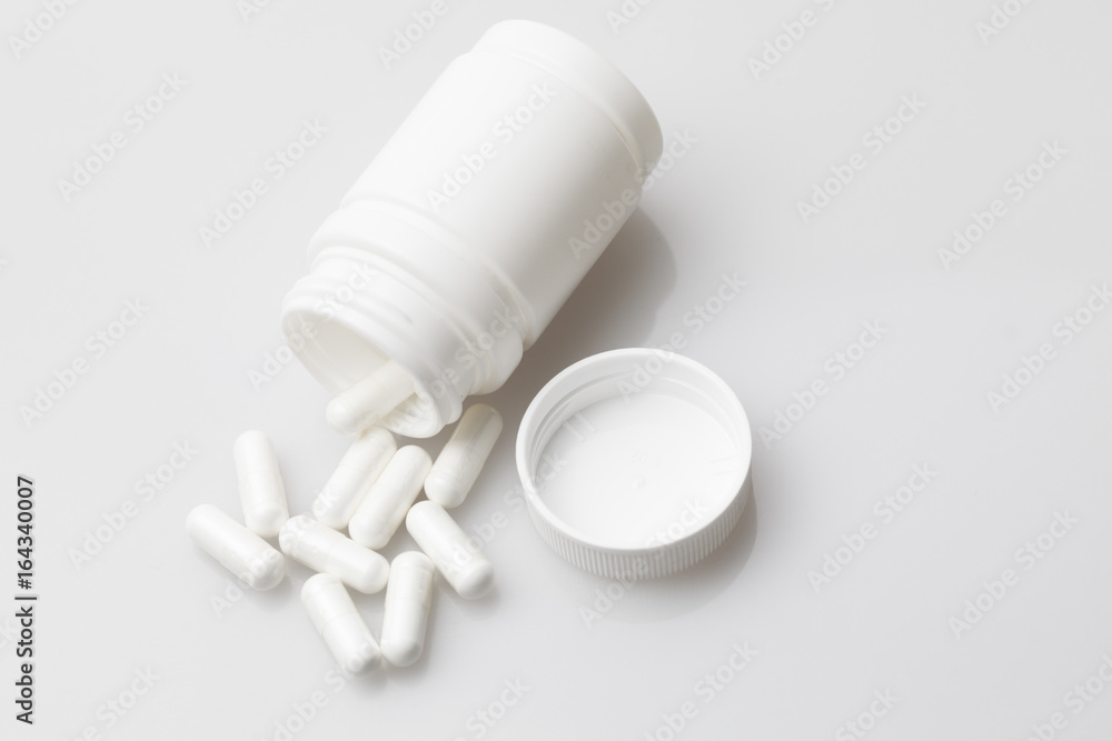 Pills and pill bottle on white background Pills and pill bottle on white background