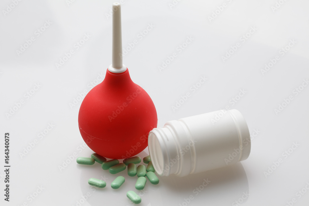 Red enema on a white background Red enema on a white background