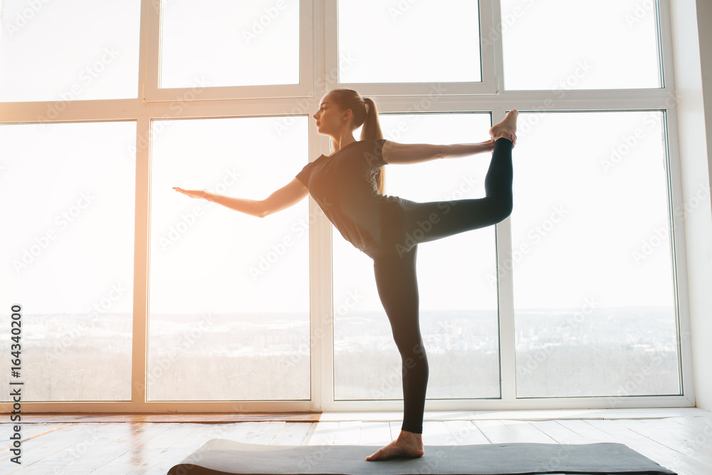 Young beautiful woman practicing yoga and gymnastic. Wellness concept. Classes in single sports. Young beautiful woman practicing yoga and gymnastic. Wellness concept. Classes in single sports.