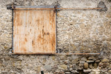 Old rustic solid metal sliding shutters in very old stone house