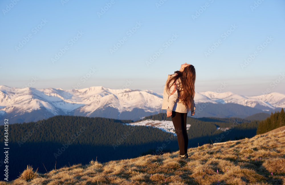 Rearview shot of a woman hiking in the mountains looking in the sky copyspace nature beautiful landscape hiker sportive human lifestyle active concept