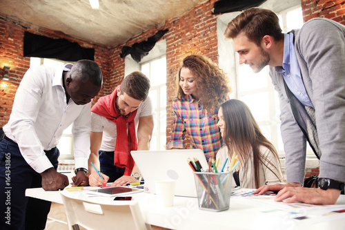 Canvas Print Group of five creative worker brainstorm together in office, new style of worksp