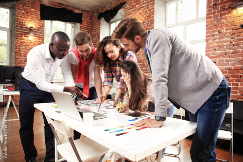 фотографія Group of five creative worker brainstorm together in office, new style of worksp