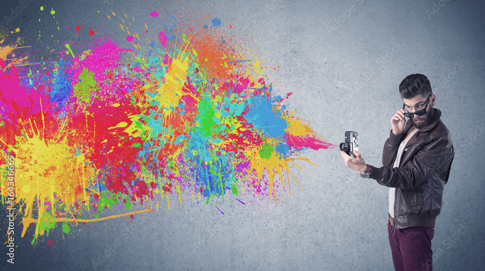 Hipster guy with camera and paint splash Hipster guy with camera and paint splash