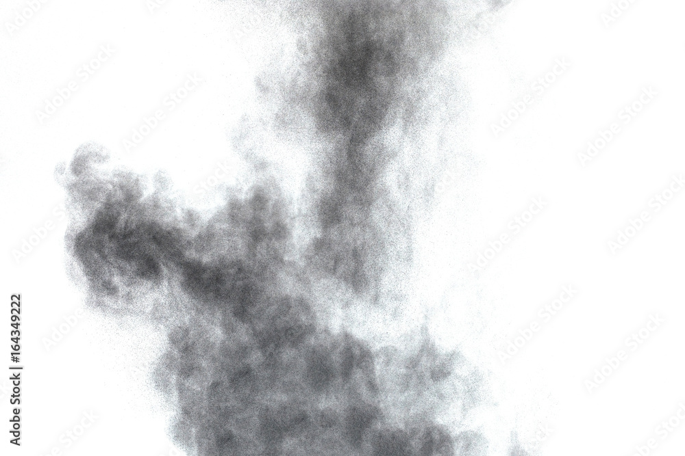 Black powder explosion. Closeup of black dust particles explode isolated on white background.