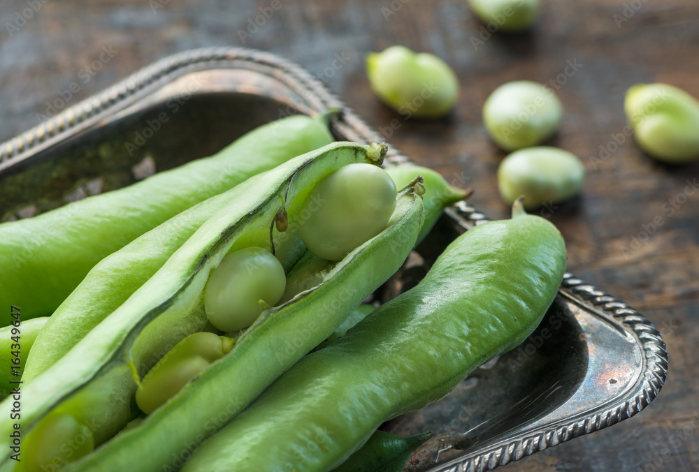 Fresh broad bean pods - closeup with selective focus Fresh broad bean pods - closeup with selective focus