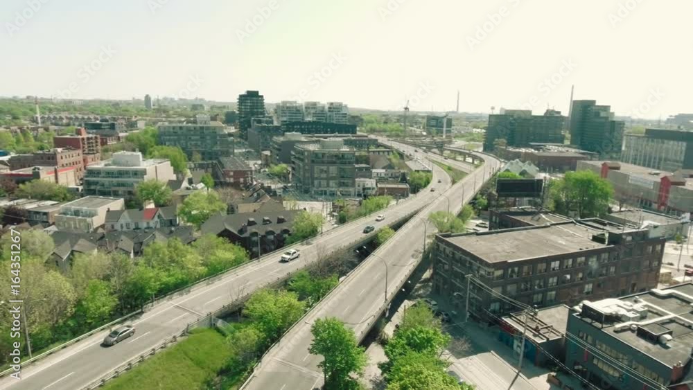 Aerial establishing shot of a street / road in a modern city during the summer / spring. Aerial establishing shot of a street / road in a modern city during the summer / spring.