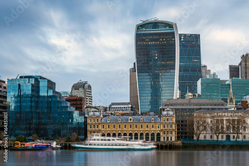 London  England - Panoramic skyline view of the famous Bank district of central London with skyscrapers  boats and blue sky